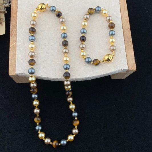 Necklace and bracelet set on a wooden stand with a dark background