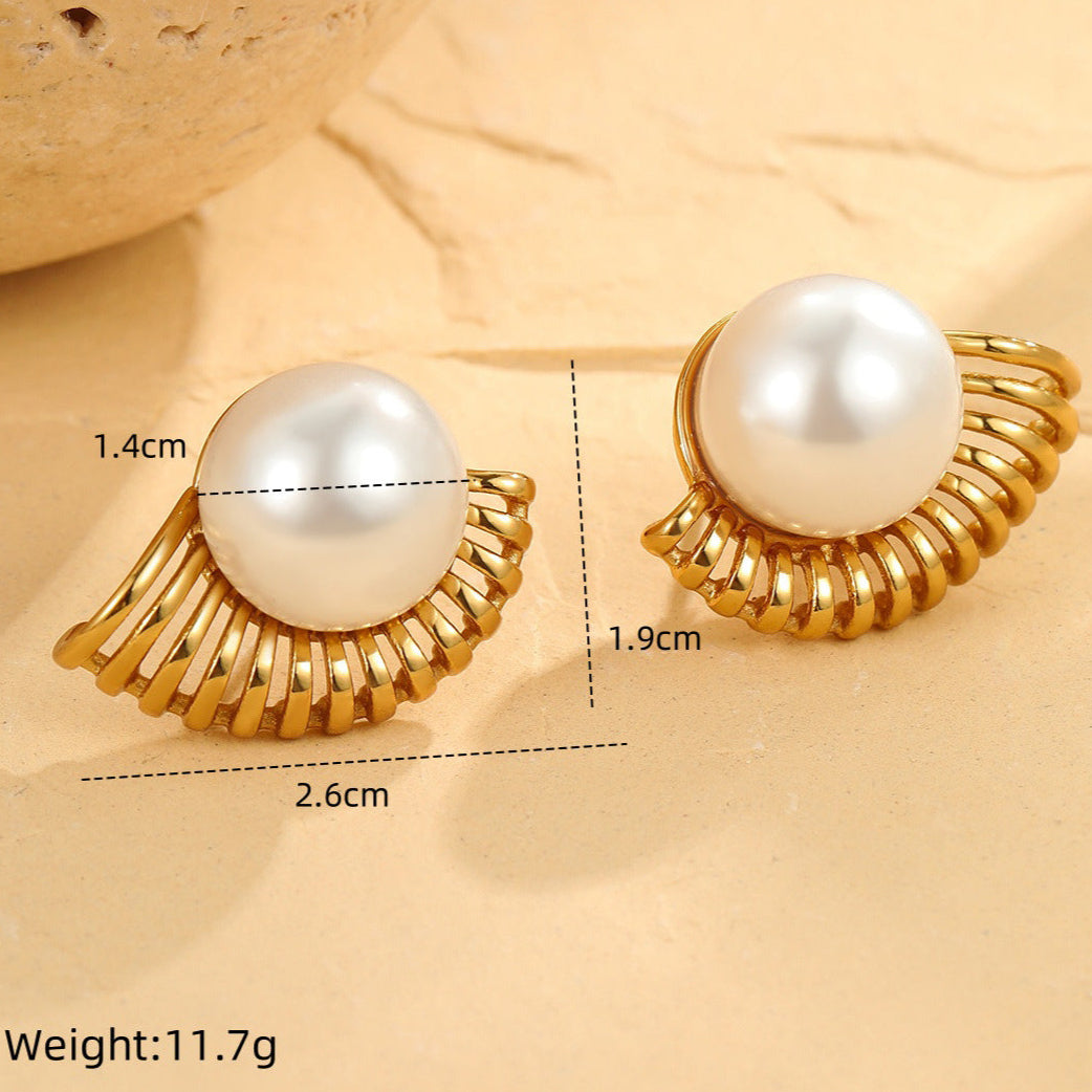 Gold-framed pearl earrings with measurements on a beige background