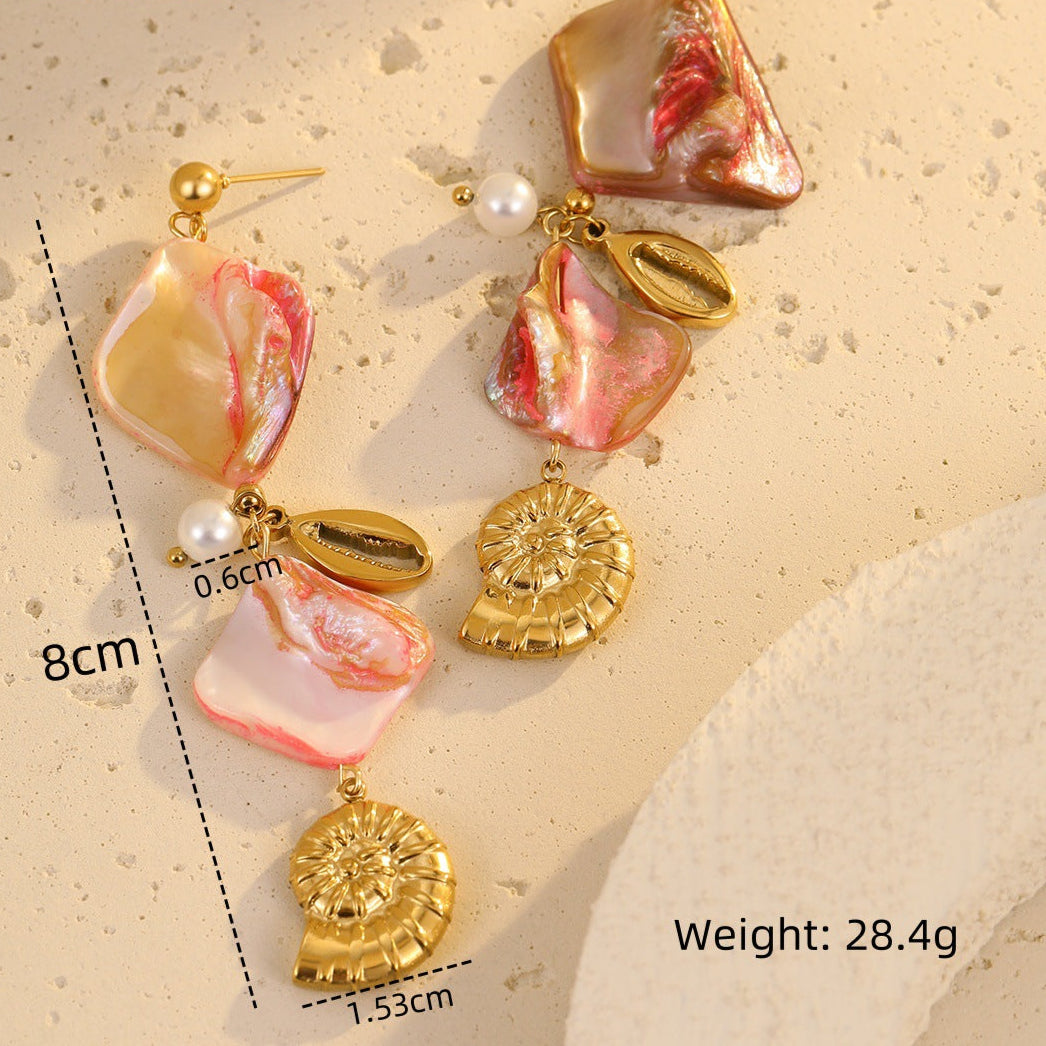 Pair of earrings with pink and gold elements on a beige background, showing measurements and weight.