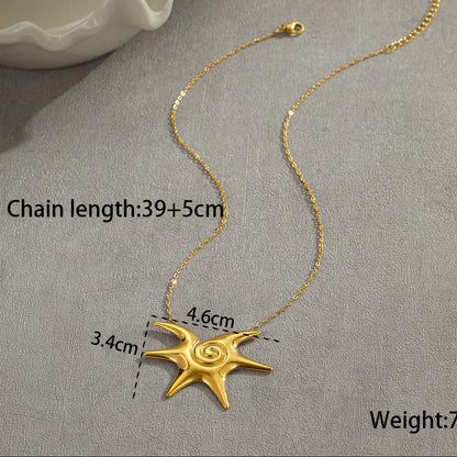 Gold necklace with a star-shaped pendant on a gray surface, showing measurements and weight.