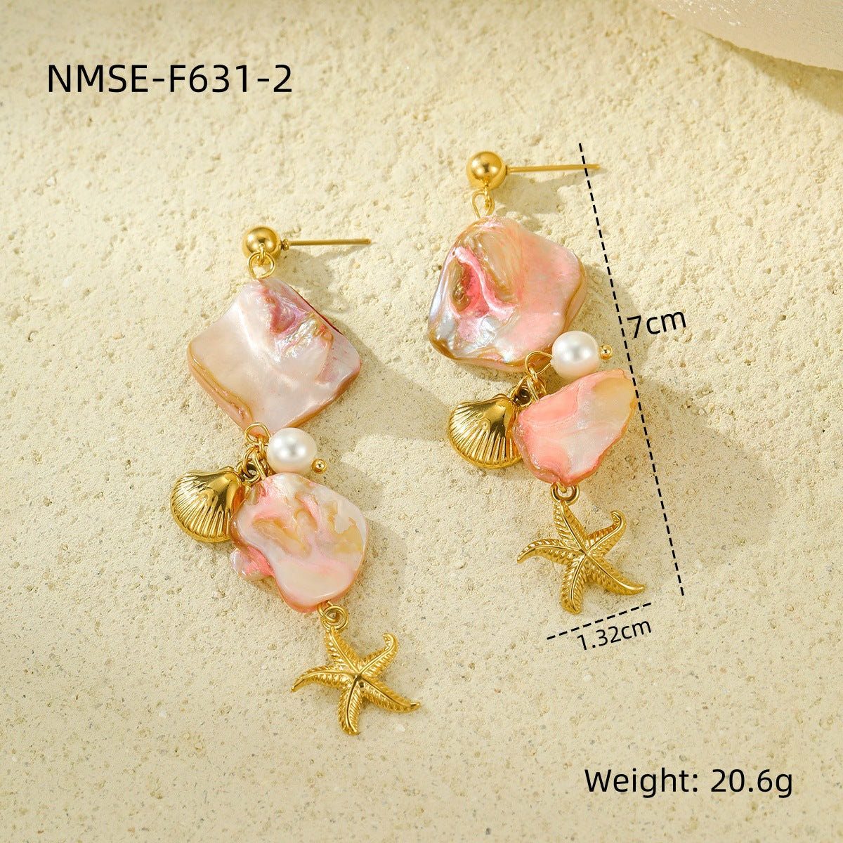 Pair of earrings with pink stones, gold shells, and starfish charms on a beige background.