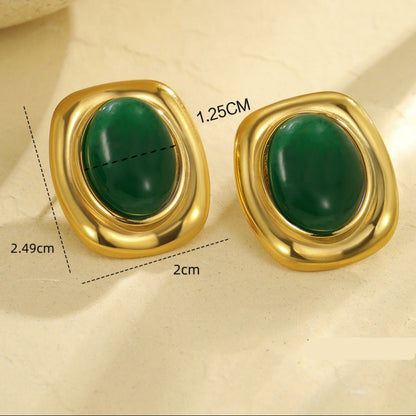 Gold earrings with green stones on a beige background, showing measurements and weight.