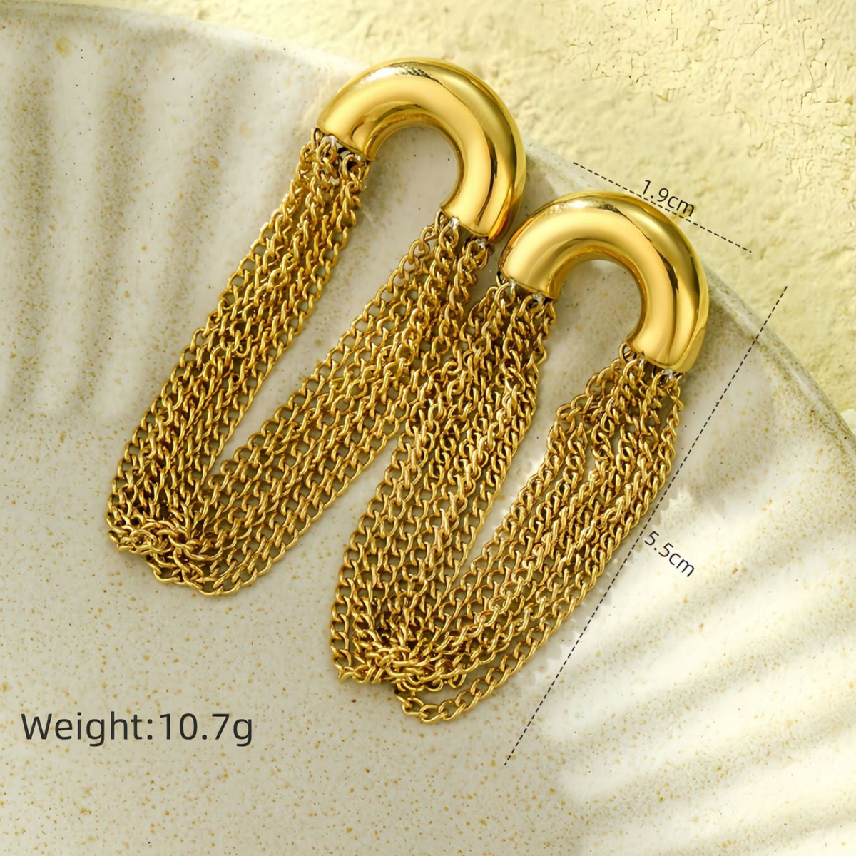 Gold chain earrings on a textured surface with measurements and weight displayed.
