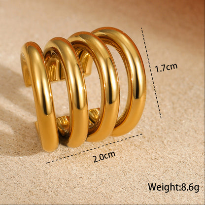 Gold spiral spring with measurements and weight on a beige background