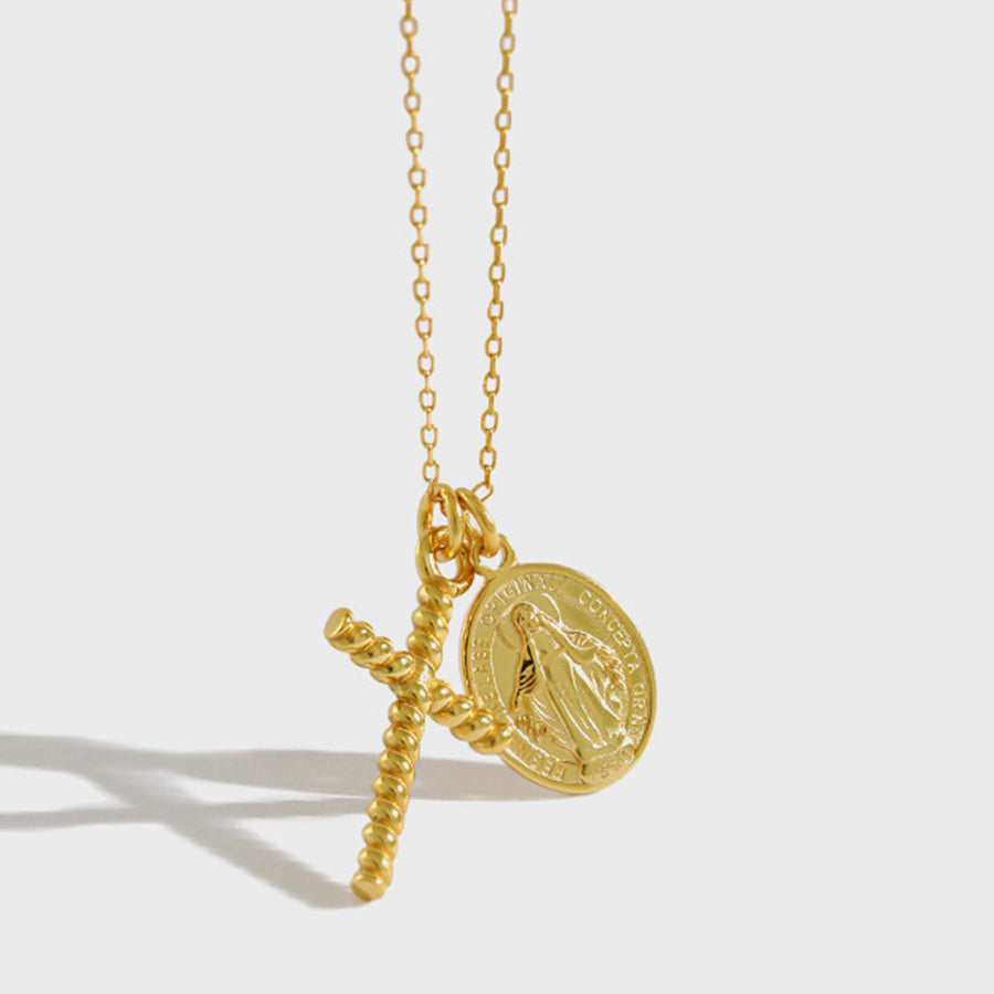 Gold necklace with a religious pendant on a white background
