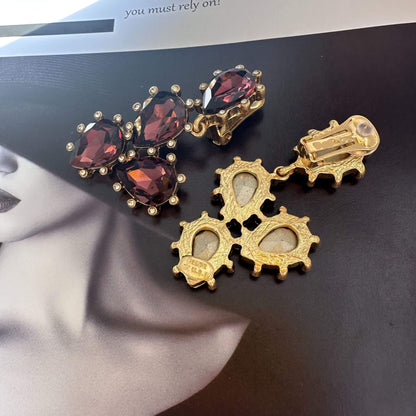 Gold earrings with gemstones on a magazine cover