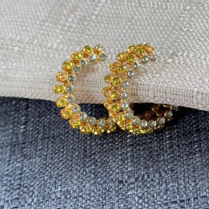 Gold hoop earrings with yellow gemstones