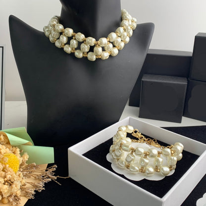 Pearl necklace and bracelet set on a mannequin with Chanel boxes in the background