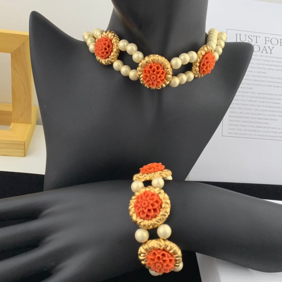 Necklace and bracelet set with floral design on a mannequin hand