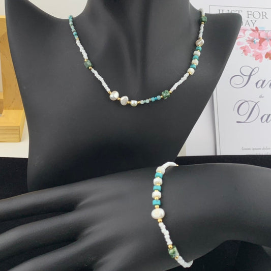 Necklace and bracelet set on a mannequin with a blurred background